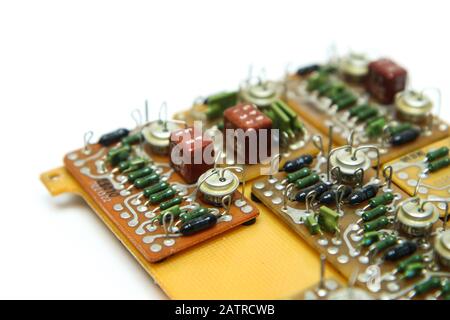 The old vintage circuit board with several electronic components. Stock Photo