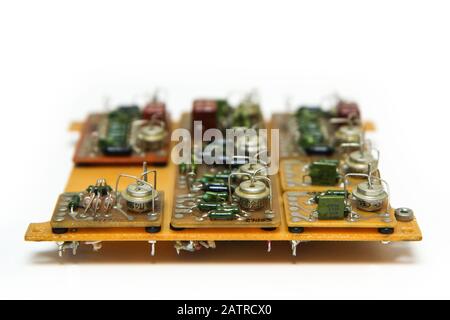 The old vintage circuit board with several electronic components. Stock Photo