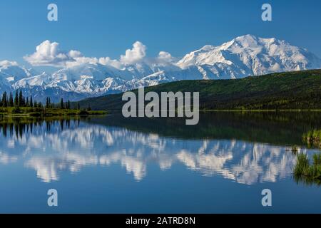 Denali shows well with the blue waters of Wonder Lake, Denali National Park and Preserve, Interior Alaska; Alaska, United States of America Stock Photo