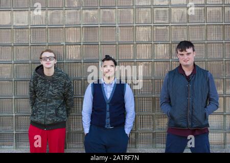 Middle Eastern man with Down Syndrome and two friends, each having a Learning Disability Stock Photo