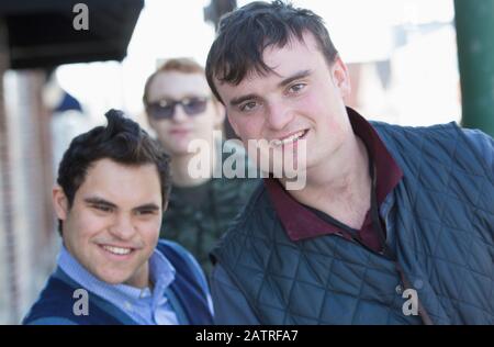 Middle Eastern man with Down Syndrome and two friends, each having a Learning Disability Stock Photo