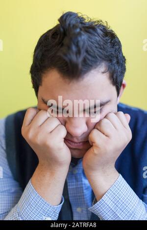Middle Eastern man with Down Syndrome thinking Stock Photo
