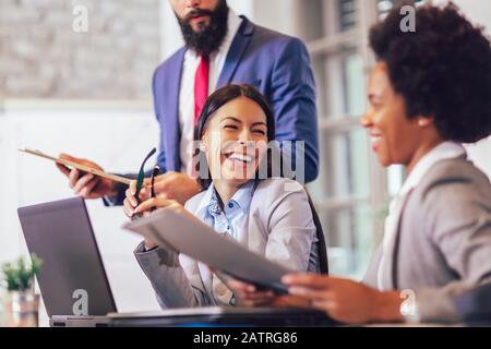 Business people having meeting around table in modern office Stock Photo