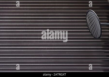 Gray metal rolling shutter door and safety mirror Stock Photo
