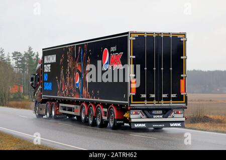 Customised Volvo FH R. M. Enberg Pepsi Max semi trailer truck on rural highway on a rainy day of winter, rear view. Salo, Finland. January 31, 2020. Stock Photo