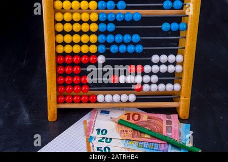Banknotes with abacus and invoice and pencil on a board Stock Photo