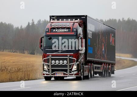 Red customised Volvo FH R. M. Enberg Pepsi Max semi trailer truck on rural highway on a rainy day of winter. Salo, Finland. January 31, 2020. Stock Photo