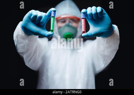 Medic in white hazmat protective epidemic coronavirus blood test. Chinese new Wuhan virus Stock Photo