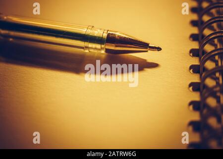 Closeup pen on a brown notebook paper. Stock Photo