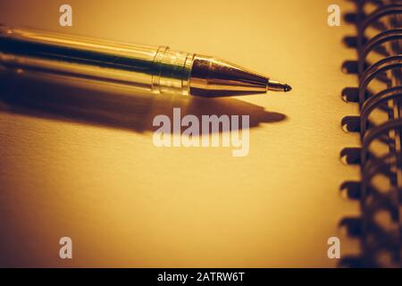Closeup pen on a brown notebook paper. Stock Photo