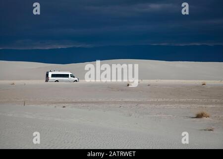 Van drives through White Sands National Monument; Alamogordo, New Mexico, United States of America Stock Photo
