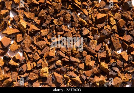 Healthy pure wild natural chaga mushroom, Inonotus obliquus pieces drying in the sun, covering whole background. Stock Photo