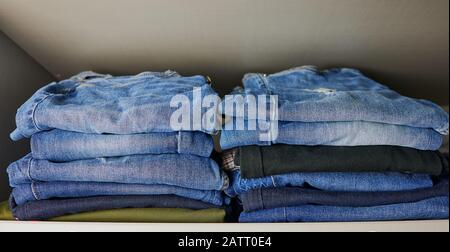 stack of female jeans in a cupboard Stock Photo