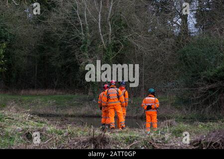 Denham, UK. 4 February, 2020. Engineers and security guards walk across land cleared for works for the HS2 high-speed rail link project in front of the river Colne. Planned works in the immediate vicinity are believed to include the felling of 200 trees and the construction of a roadway, Bailey bridge, compounds, fencing and a parking area. There is a wetland nature reserve forming part of a Site of Metropolitan Importance for Nature Conservation (SMI) on the other side of the river. Credit: Mark Kerrison/Ģ����ý Live News Stock Photo