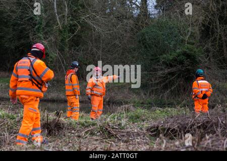 Denham, UK. 4 February, 2020. Engineers and security guards walk across land cleared for works for the HS2 high-speed rail link project in front of the river Colne. Planned works in the immediate vicinity are believed to include the felling of 200 trees and the construction of a roadway, Bailey bridge, compounds, fencing and a parking area. There is a wetland nature reserve forming part of a Site of Metropolitan Importance for Nature Conservation (SMI) on the other side of the river. Credit: Mark Kerrison/Ģ����ý Live News Stock Photo