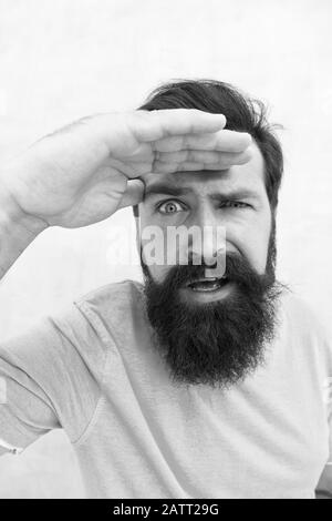 Suspicious look. Man bearded hipster stylish beard grey background. Perceptions of male beauty. Stylish beard and mustache care. Strict face. Beard fashion barber. Handsome guy. Masculinity concept. Stock Photo