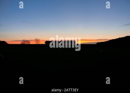 2 Direct rail services class 68 locomotives passing Silverdale (between Carnforth & Arnside) running light engine at sunset Stock Photo