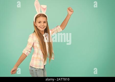 No easter party is complete without easter bunny. Fashion accessory for easter party. Small girl child in easter bunny style. Cute little girl wearing bunny ears headband. Looking pretty and adorable. Stock Photo