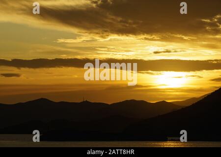 Majestic sunrise over the mountains and the sea. Stock Photo