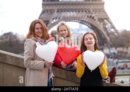 family trip. Happy mom and daughters on the background of the Eiffel Tower in Paris. France Stock Photo