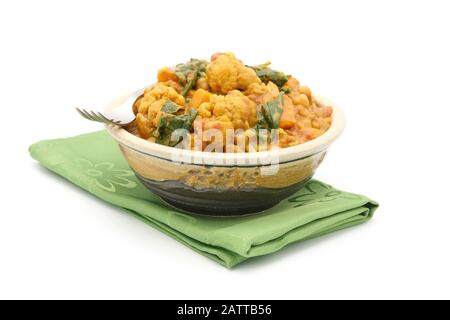 Homemade coconut cauliflower curry in an ornate bowl on a white background. Stock Photo