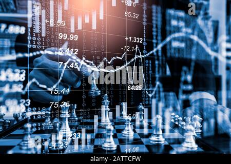 Chess game on chess board on stock market or forex trading graph chart for financial investment concept. Economy trends for digital business marketing Stock Photo