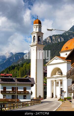 view of church, tower and street in italian  town Auronzo di Cadore Stock Photo