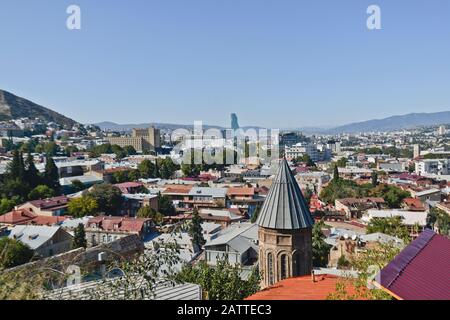 Tbilisi: Saint Nicholas Church, with a panoramic view of the city center from Mount Mtatsminda in the background (Georgia) Stock Photo