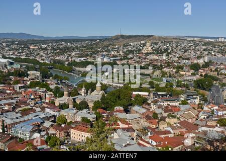 Panoramic wide angle view of Tbilisi from Sololaki Hill, with the Kura river crossing the city center and mountains in the background  (Georgia) Stock Photo