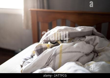 Messy duvet on a bed Stock Photo