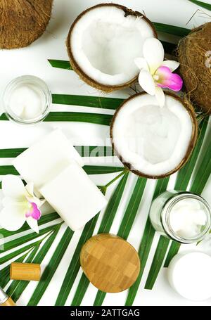 Coconut cosmetics theme flat lay creative layout overhead with pro environment alternative plastic free soaps, moisturizers and beauty products. Verti Stock Photo