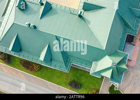 aerial top down photo of green tiled metal sloping roof with dormer windows Stock Photo