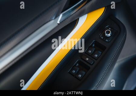 Interior of modern car. Car inside: side door buttons: window adjustment buttons, door lock.  Stock Photo