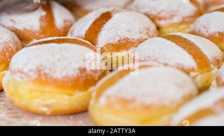 Close up of austrian Krapfen (english: doughnuts). Fried, with powdered sugar. Popular food in german speaking countries. Also known as Berliner. Stock Photo