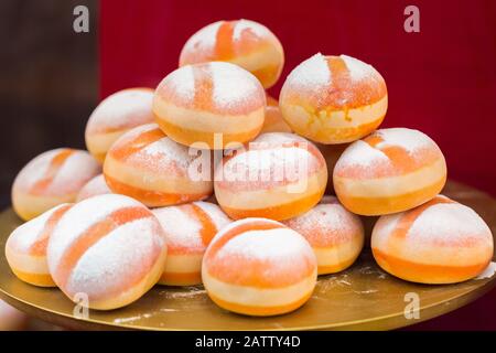 A pile / pyramid of smaller sized Krapfen (so-called Puppenkrapfen - a kind of donut). Austrian speciality. Called Berliner in northern Germany. Stock Photo