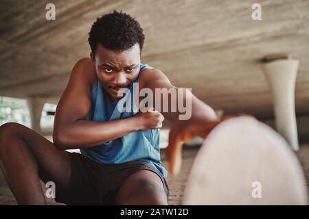 Foto de City fitness, arm stretch and man exercise at sunrise