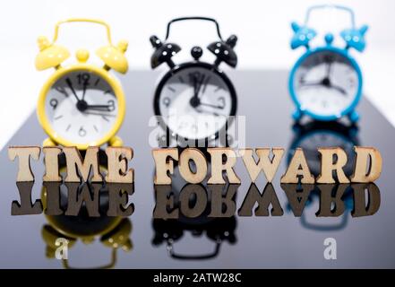 Daylight Saving Time. DST. Wall Clock going to winter time. Turn time forward. Abstract photo of changing time at spring. Stock Photo