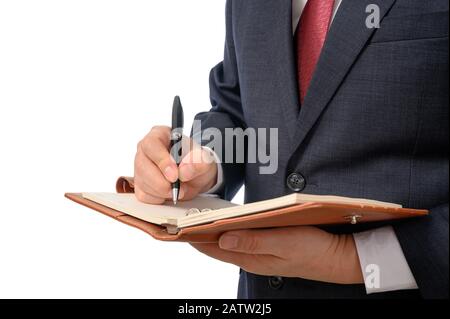 Businessman with a notebook in his hand and a pen to write something Stock Photo