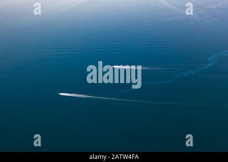 Aerial drone birds eye view of sail boat cruising in the deep blue Aegean sea, Greece. Stock Photo