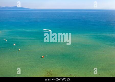 Aerial drone birds eye view of sail boat cruising in the deep blue Aegean sea, Greece. Stock Photo