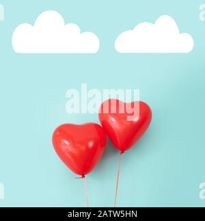 Two heart shaped red air baloon front of a font. Valentined day and romance concept Stock Photo