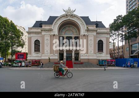 Ho Chi Minh City, Vietnam - August 24, 2017: City Opera House with hawker street vendor on scooter, Ho Cho Ming City, Saigon, VIetnam Stock Photo