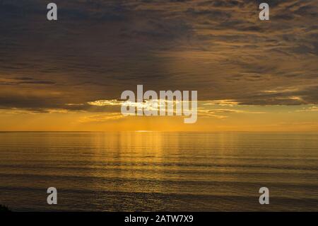 Spectacular sunset seascape with dramatic sky and colorful water Stock Photo