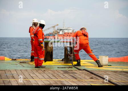 AHTS vessel marine crew carried out anchor handling operation on deck Stock Photo