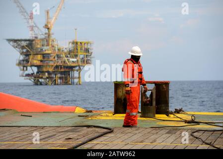 marine crew doing anchor handling operation at sea for four point mooring anchor work boat at sea Stock Photo