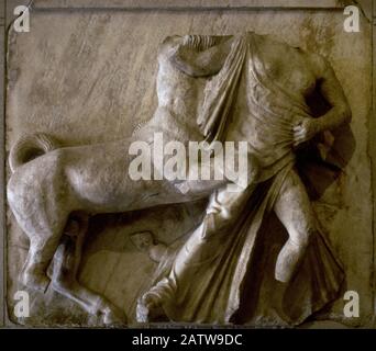 Greece. Metope of the Parthenon (5th century BC). Scene from the Centauromachy. Mythical centaurs fought with the Lapiths. The combat took place during the wedding celebrations of Pirithous, King of the Lapiths, at which the drunken centaurs attempted to abduct the wives of their hosts. This relief depicts the abduction of a Lapith woman by one of the centaurs. By Phidias (490-432 BC). From Athens. Louvre Museum. Paris, France. Stock Photo