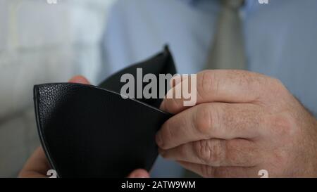 Businessman Searching in His Empty Wallet Cash or Credit Cards, Insolvency in Payments, Financial Crisis and Bankruptcy Stock Photo