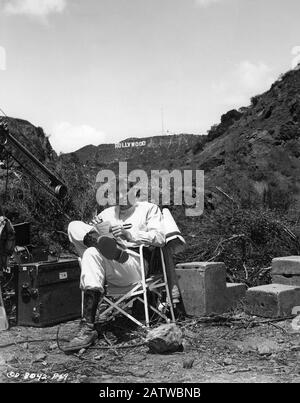 BURT LANCASTER in French Foreign Legion costume on set location candid in Bronson Canyon Griffith Park Los Angeles with HOLLYWOOD SIGN behind during filming of TEN TALL MEN 1951 director Willis Goldbeck  Norma Productions / Halburt Productions / Columbia Pictures Stock Photo