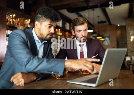 Handsome two businessmen have a meeting in a restaurant Stock Photo