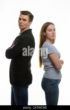 The couple got into a fight and standing with their backs to each other in the frame Stock Photo